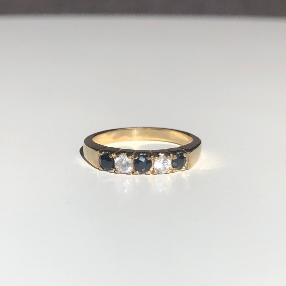 Gold Tone Ring with Black Diamonds and White Stone
